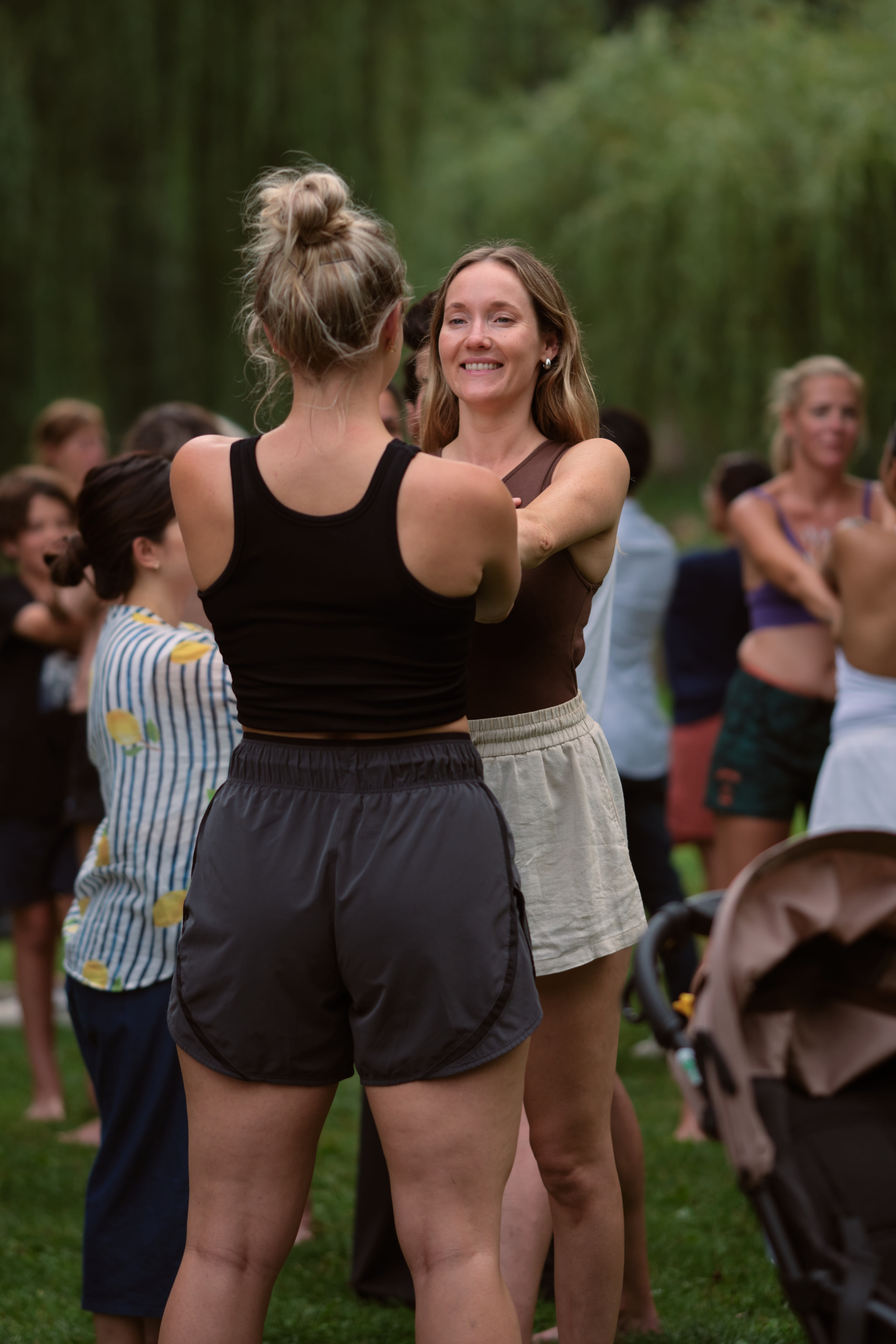 Group practicing Fascial Maneuvers together outdoors in a park
